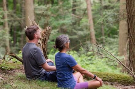 two people meditating outside