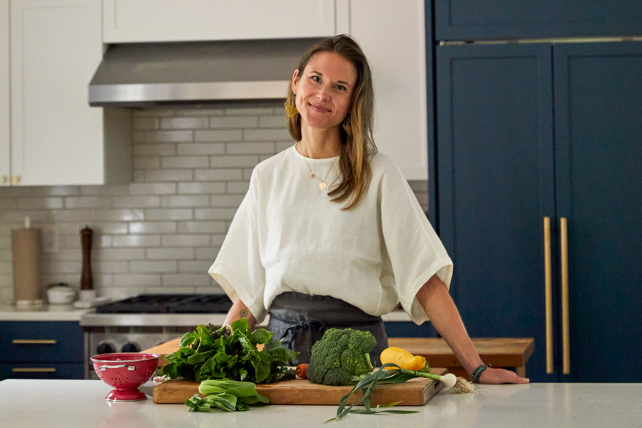 Photo of Nicki Sizemore in a kitchen preparing vegetables.
